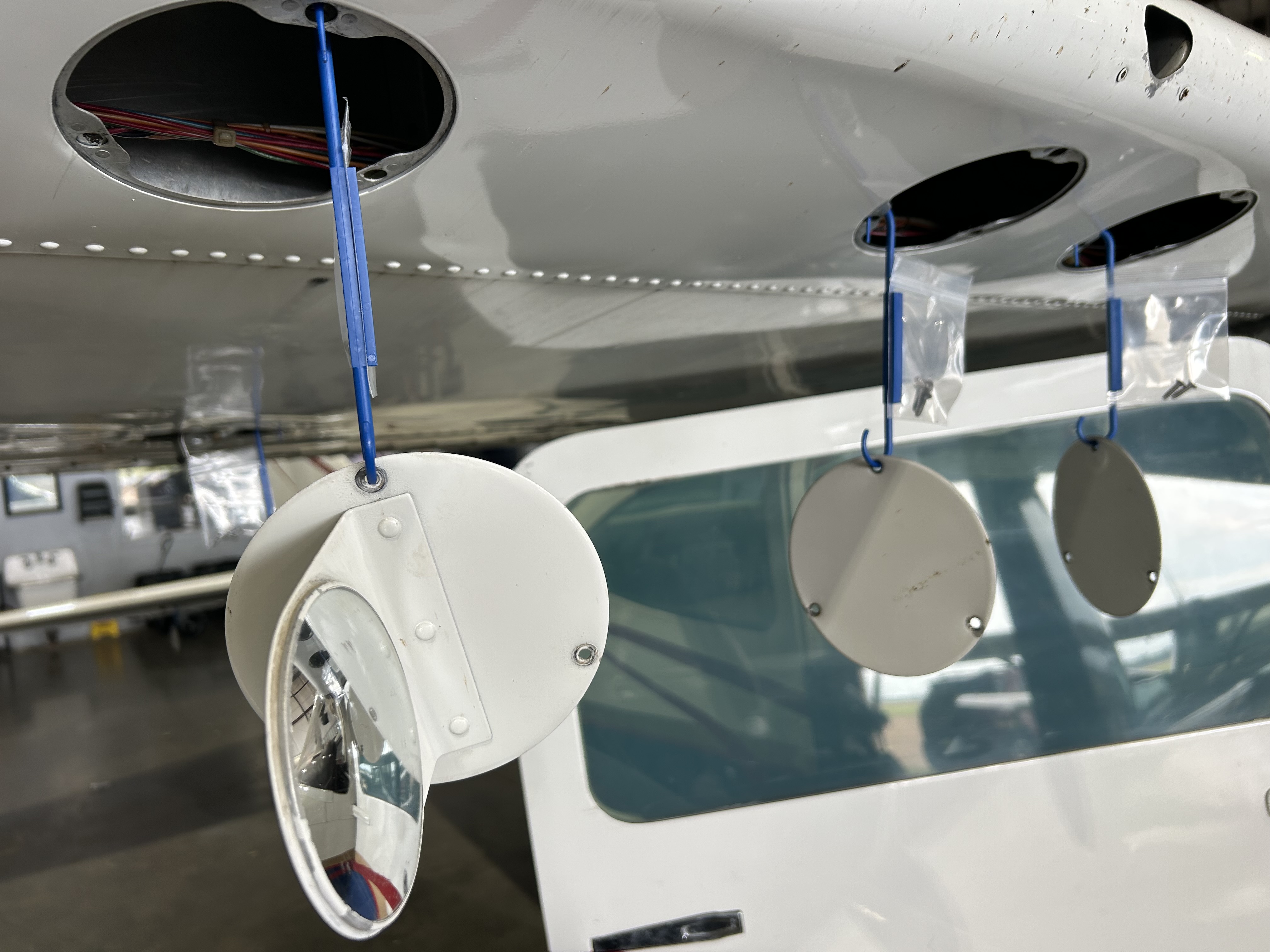 Multiple Hangar Bags holding panels on aircraft belly